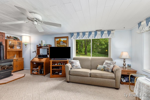 10667 220th Ave, Big Rapids, MI 49307 - living area featuring a wood stove, carpet floors, and a ceiling fan