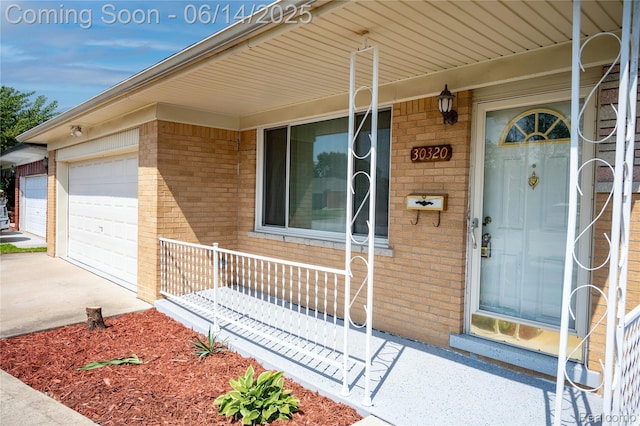 30320 Moulin Ave, Warren, MI 48088 - property entrance featuring brick siding, a porch, an attached garage, and driveway