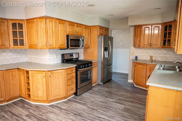 30320 Moulin Ave, Warren, MI 48088 - kitchen featuring appliances with stainless steel finishes, dark wood-style floors, decorative backsplash, and glass insert cabinets