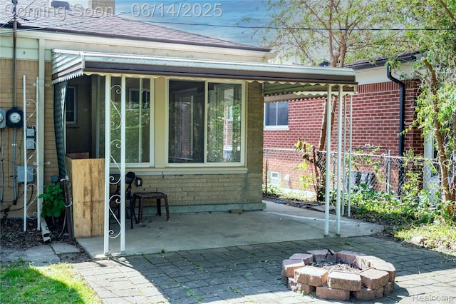 30320 Moulin Ave, Warren, MI 48088 - back of house with brick siding, an outdoor fire pit, and a patio