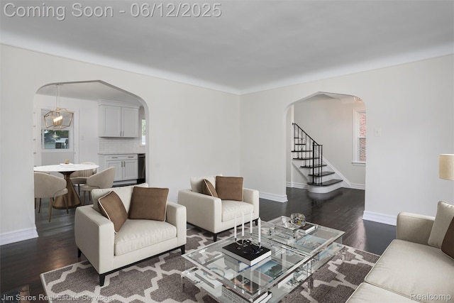 249 Ridgemont Rd, Grosse Pointe, MI 48236 - living room featuring arched walkways, dark wood-type flooring, and stairs