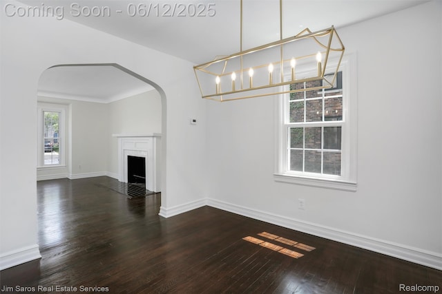 249 Ridgemont Rd, Grosse Pointe, MI 48236 - unfurnished living room featuring arched walkways, hardwood / wood-style flooring, and a fireplace