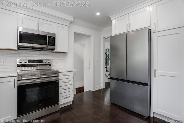 249 Ridgemont Rd, Grosse Pointe, MI 48236 - kitchen with appliances with stainless steel finishes, tasteful backsplash, recessed lighting, white cabinetry, and dark wood-style floors