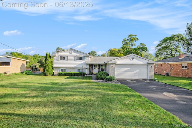 3255 School House Dr, Waterford, MI 48329 - split level home with driveway, an attached garage, brick siding, and a front yard