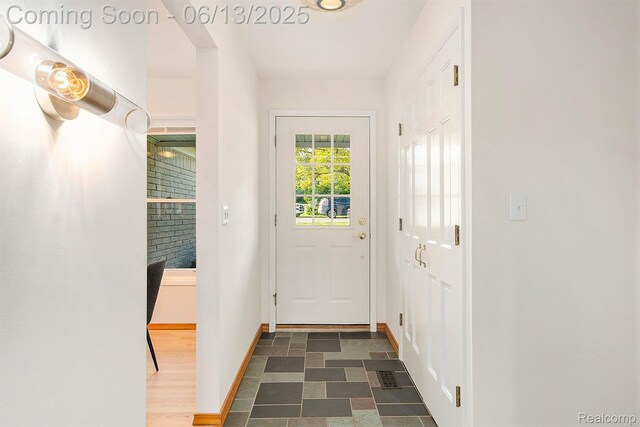 3255 School House Dr, Waterford, MI 48329 - doorway to outside featuring baseboards