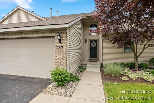 2321 S Highland View Cir SE, Grand Rapids, MI 49506 - view of front of house featuring roof with shingles, an attached garage, brick siding, and driveway