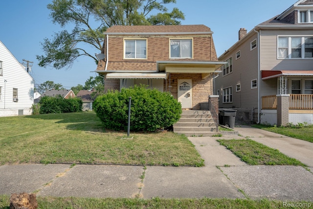 2476 Ford St, Detroit, MI 48238 - view of front facade with a front lawn, brick siding, and a shingled roof