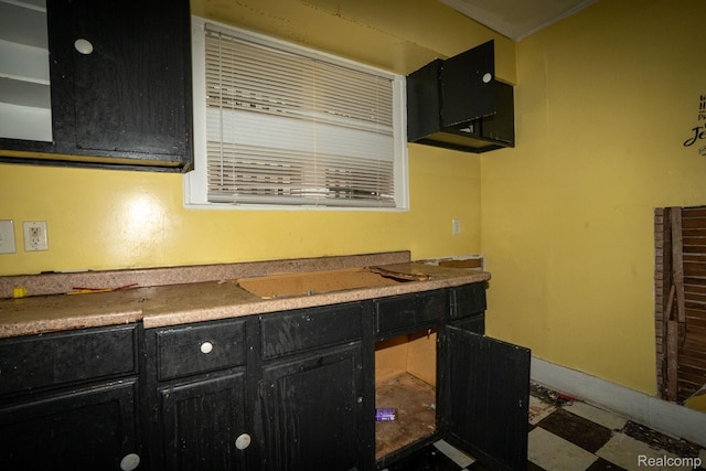 2476 Ford St, Detroit, MI 48238 - kitchen with dark cabinetry and tile patterned floors