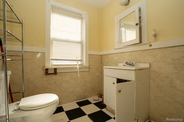 2476 Ford St, Detroit, MI 48238 - bathroom with tile patterned floors, plenty of natural light, a wainscoted wall, and vanity
