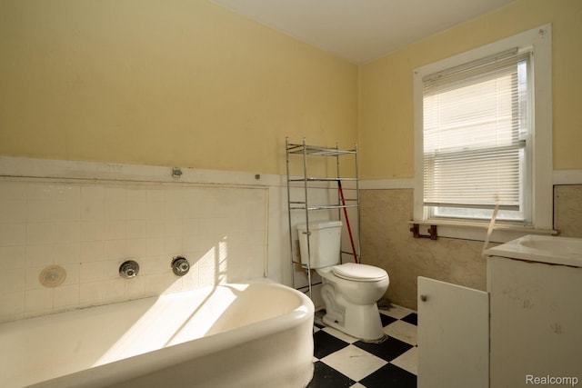 2476 Ford St, Detroit, MI 48238 - full bath featuring tile patterned floors, a bathtub, wainscoting, tile walls, and vanity