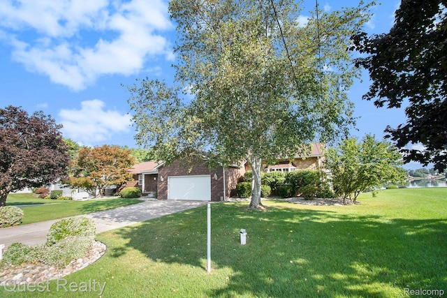 14050 Shannon Dr, Cement City, MI 49233 - obstructed view of property featuring a front lawn, an attached garage, driveway, and brick siding