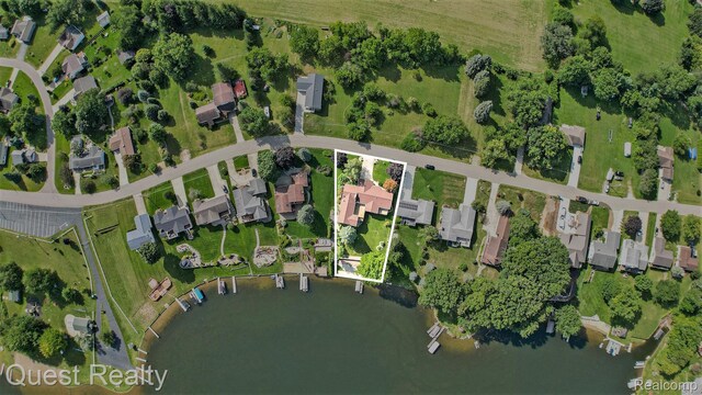 14050 Shannon Dr, Cement City, MI 49233 - aerial view of property's location featuring property boundaries highlighted, a nearby body of water, and nearby suburban area