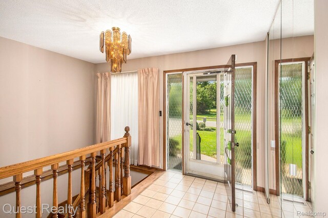 14050 Shannon Dr, Cement City, MI 49233 - doorway with a chandelier and light tile patterned flooring