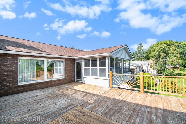 14050 Shannon Dr, Cement City, MI 49233 - wooden deck with a sunroom