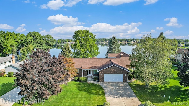 14050 Shannon Dr, Cement City, MI 49233 - view of front of property with an attached garage, a front lawn, driveway, a water view, and brick siding