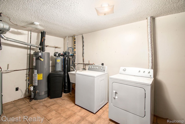 14050 Shannon Dr, Cement City, MI 49233 - washroom with gas water heater, washer and dryer, a textured ceiling, and light tile patterned floors