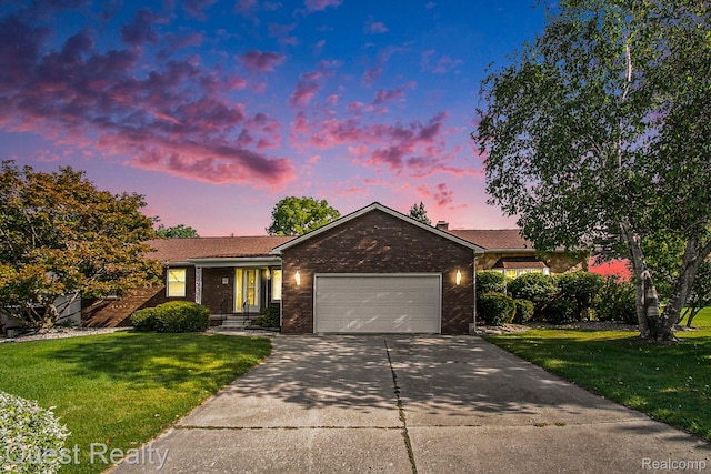 14050 Shannon Dr, Cement City, MI 49233 - single story home with a garage, brick siding, concrete driveway, and a lawn