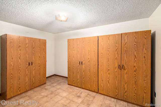 14050 Shannon Dr, Cement City, MI 49233 - unfurnished bedroom with a closet and a textured ceiling
