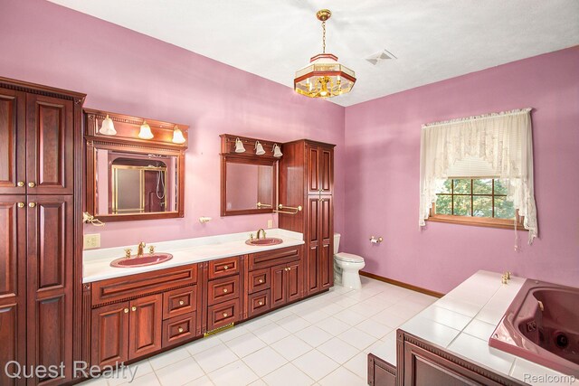 14050 Shannon Dr, Cement City, MI 49233 - bathroom featuring double vanity, a jetted tub, and tile patterned floors