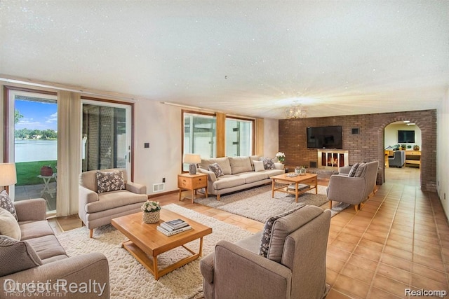 14050 Shannon Dr, Cement City, MI 49233 - living area featuring arched walkways, plenty of natural light, and a textured ceiling