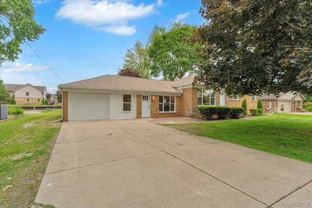 27853 Johnson Rd, Grosse Ile, MI 48138 - ranch-style home featuring brick siding, an attached garage, concrete driveway, and a front yard