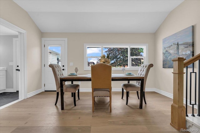 27853 Johnson Rd, Grosse Ile, MI 48138 - dining space featuring light wood-style flooring, healthy amount of natural light, and lofted ceiling