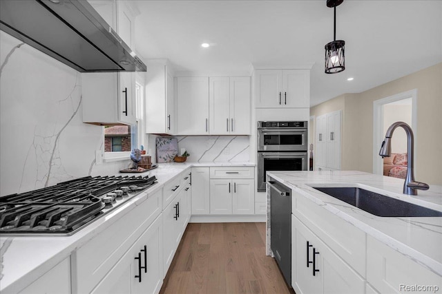 27853 Johnson Rd, Grosse Ile, MI 48138 - kitchen featuring custom range hood, stainless steel appliances, white cabinetry, tasteful backsplash, and recessed lighting