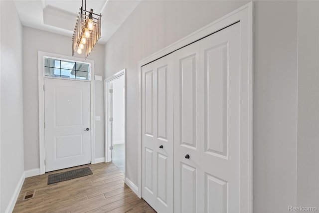 47467 Bayside Cir W, Chesterfield, MI 48047 - foyer entrance featuring light wood-style floors and a chandelier