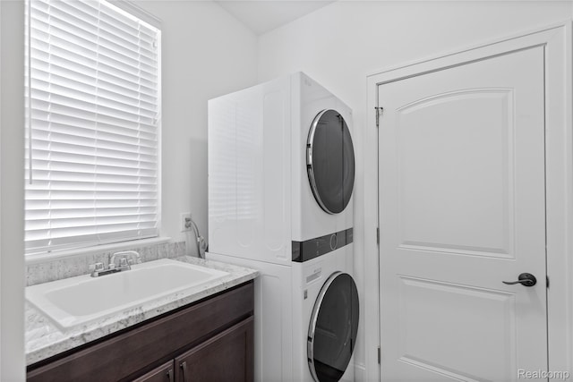 47467 Bayside Cir W, Chesterfield, MI 48047 - washroom featuring stacked washing machine and dryer and cabinet space