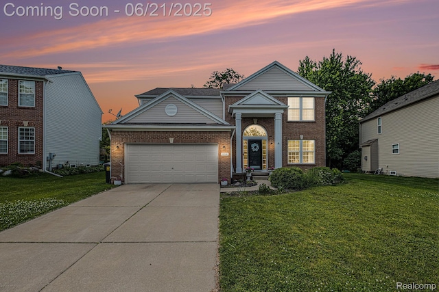 894 Canyon Creek Dr, Holly, MI 48442 - view of front of house featuring an attached garage, a front lawn, driveway, and brick siding
