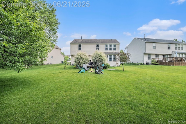 894 Canyon Creek Dr, Holly, MI 48442 - back of house featuring a lawn