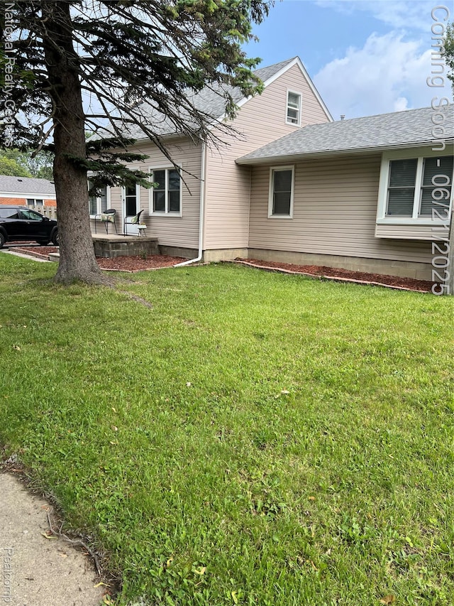 13203 Frazho Rd, Warren, MI 48089 - view of side of home with a shingled roof and a lawn