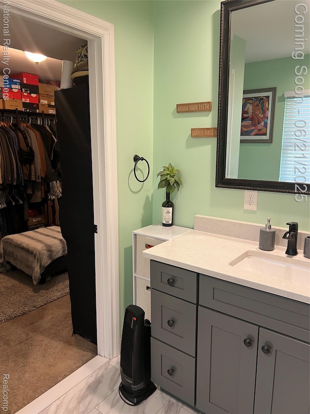 13203 Frazho Rd, Warren, MI 48089 - bathroom with marble look tiles, vanity, and a walk in closet