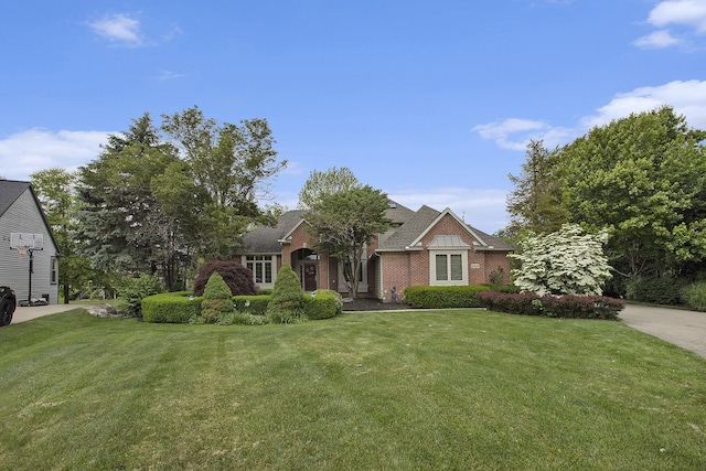 5448 Waterfield Ct, Ann Arbor, MI 48108 - view of front of home with a front yard, brick siding, and a shingled roof