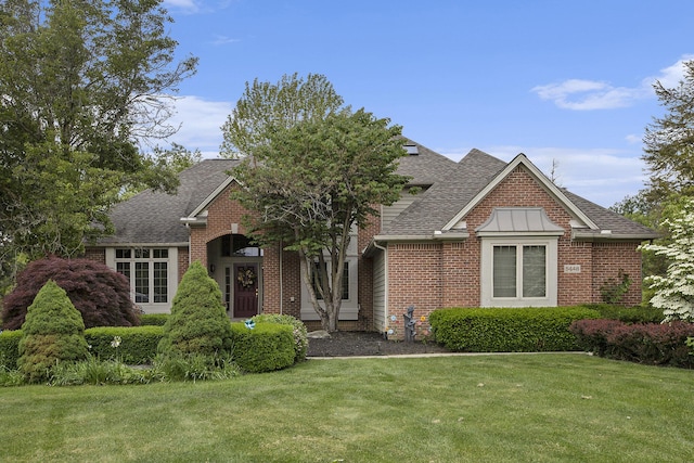 5448 Waterfield Ct, Ann Arbor, MI 48108 - view of front of house with roof with shingles, a front yard, and brick siding