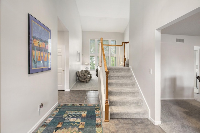 5448 Waterfield Ct, Ann Arbor, MI 48108 - stairs featuring lofted ceiling and tile patterned floors
