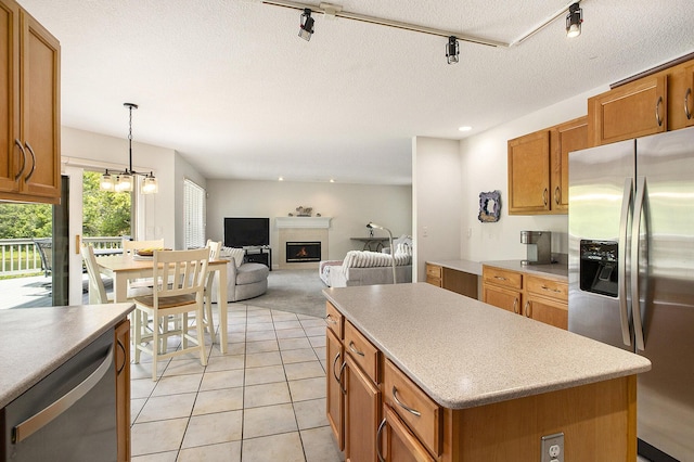 5448 Waterfield Ct, Ann Arbor, MI 48108 - kitchen featuring appliances with stainless steel finishes, track lighting, brown cabinets, a textured ceiling, and recessed lighting