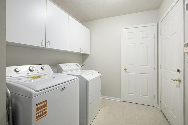 5448 Waterfield Ct, Ann Arbor, MI 48108 - laundry room featuring cabinet space, separate washer and dryer, light tile patterned flooring, and a textured ceiling