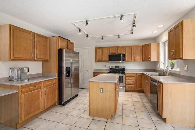 5448 Waterfield Ct, Ann Arbor, MI 48108 - kitchen with stainless steel appliances, a kitchen island, light countertops, light tile patterned floors, and a textured ceiling