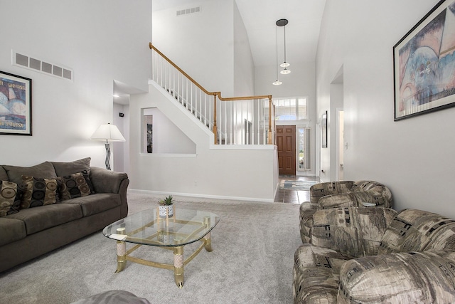5448 Waterfield Ct, Ann Arbor, MI 48108 - carpeted living room featuring a towering ceiling and stairway