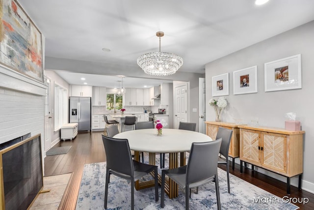 2243 Cambridge Dr SE, Grand Rapids, MI 49506 - dining room with recessed lighting, a large fireplace, hardwood / wood-style flooring, and a chandelier