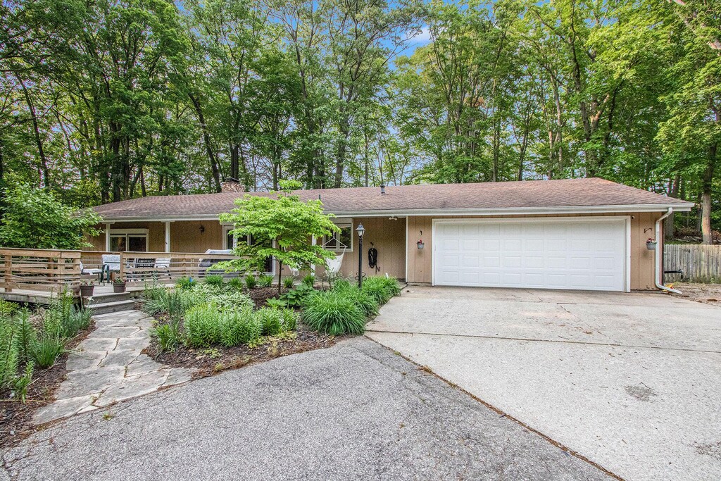 7238 Willobee St, Coloma, MI 49038 - view of front of property with driveway, a garage, covered porch, and a chimney