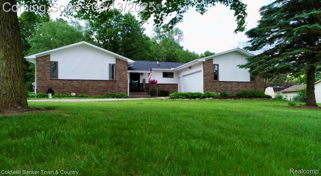 8811 Coyle Dr, Pinckney, MI 48169 - ranch-style home with brick siding, a garage, and a front lawn