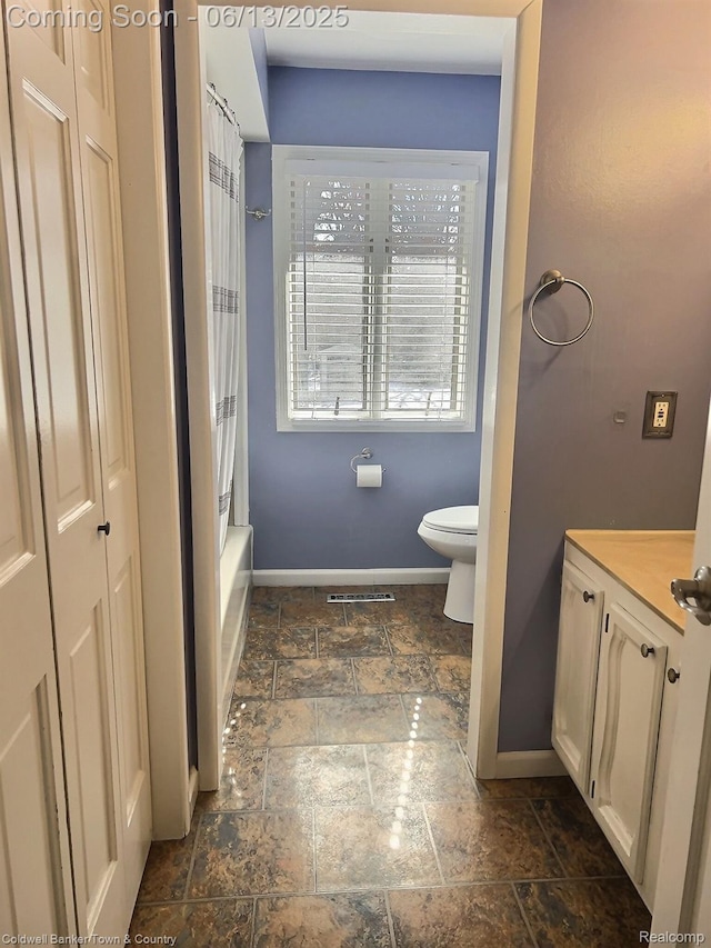 8811 Coyle Dr, Pinckney, MI 48169 - bathroom with stone tile flooring, vanity, and shower / bath combo