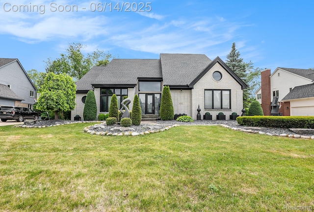 4322 Darlene Dr, Commerce Twp, MI 48382 - french country home with brick siding, a front yard, and a shingled roof