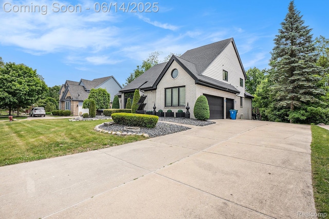 4322 Darlene Dr, Commerce Twp, MI 48382 - view of property exterior featuring a garage, brick siding, driveway, and a yard