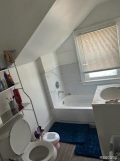 19131 Cliff St, Detroit, MI 48234 - full bath with vaulted ceiling, a tub, wood finished floors, and vanity