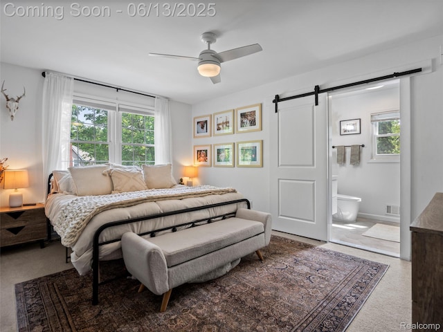 2147 Princeton Rd, Berkley, MI 48072 - bedroom with a barn door, multiple windows, ensuite bathroom, and a ceiling fan