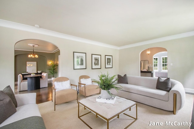 1101 Cadillac Dr SE, Grand Rapids, MI 49506 - living room with arched walkways, ornamental molding, radiator, and a chandelier