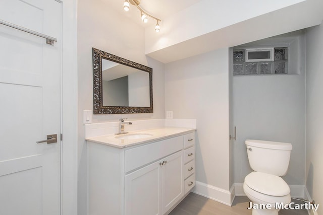1101 Cadillac Dr SE, Grand Rapids, MI 49506 - half bathroom featuring vanity and wood finished floors